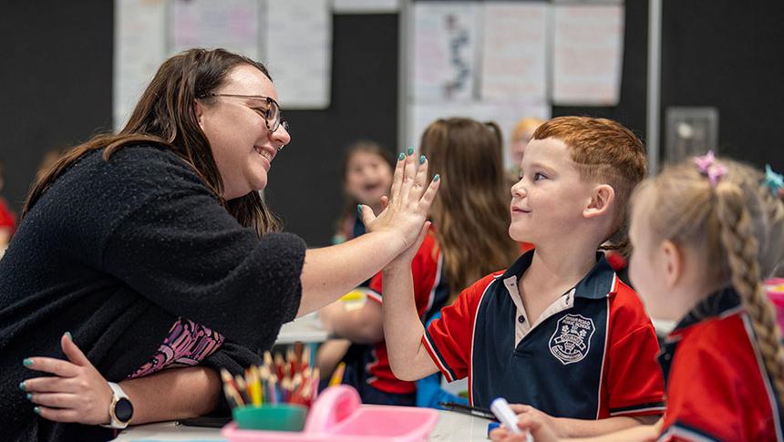 Teacher high fiving student