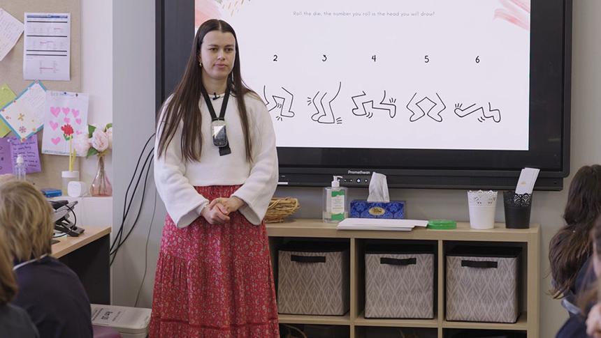 Teacher standing in front of class demonstrating deliberate pause