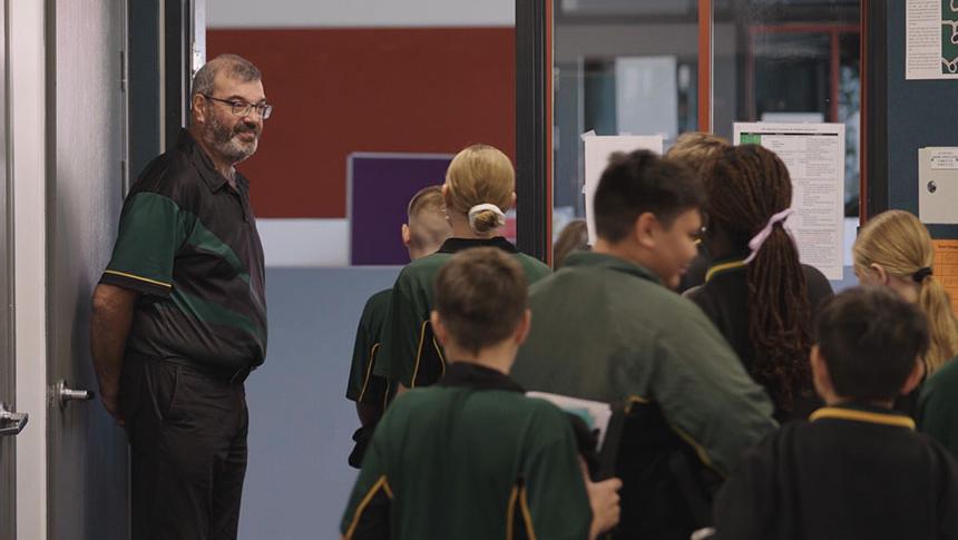 Teacher saying goodbye to students as they leave the classroom