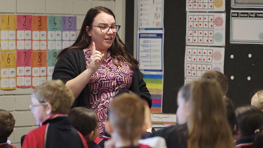 A teacher speaking in front of students